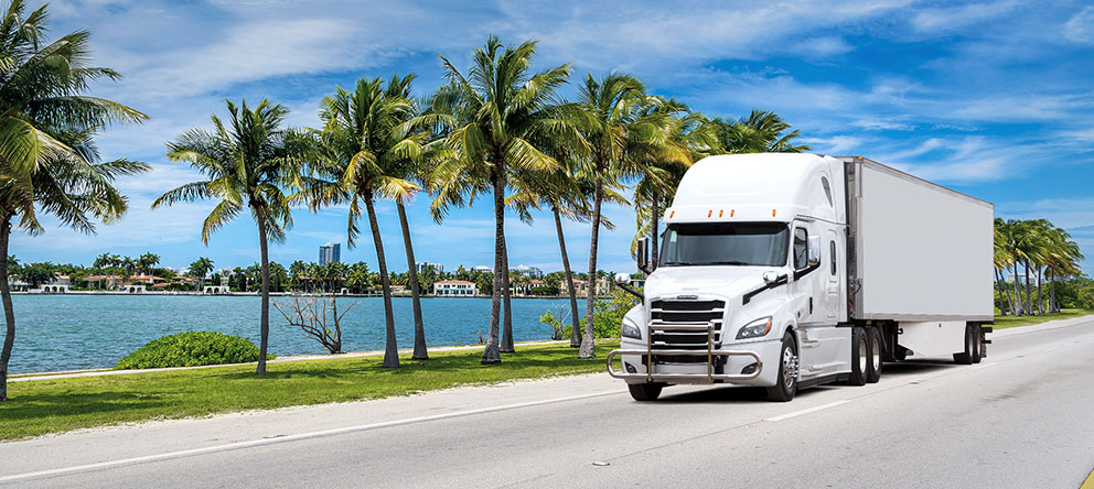 White tractor trailer transporting freight in Florida, USA